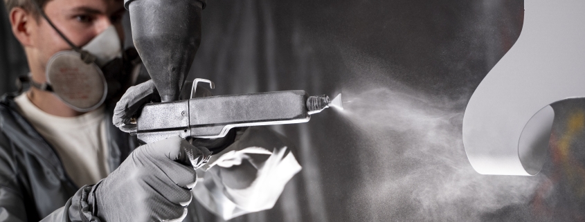 man-working-with-paint-gun-medium-shot
